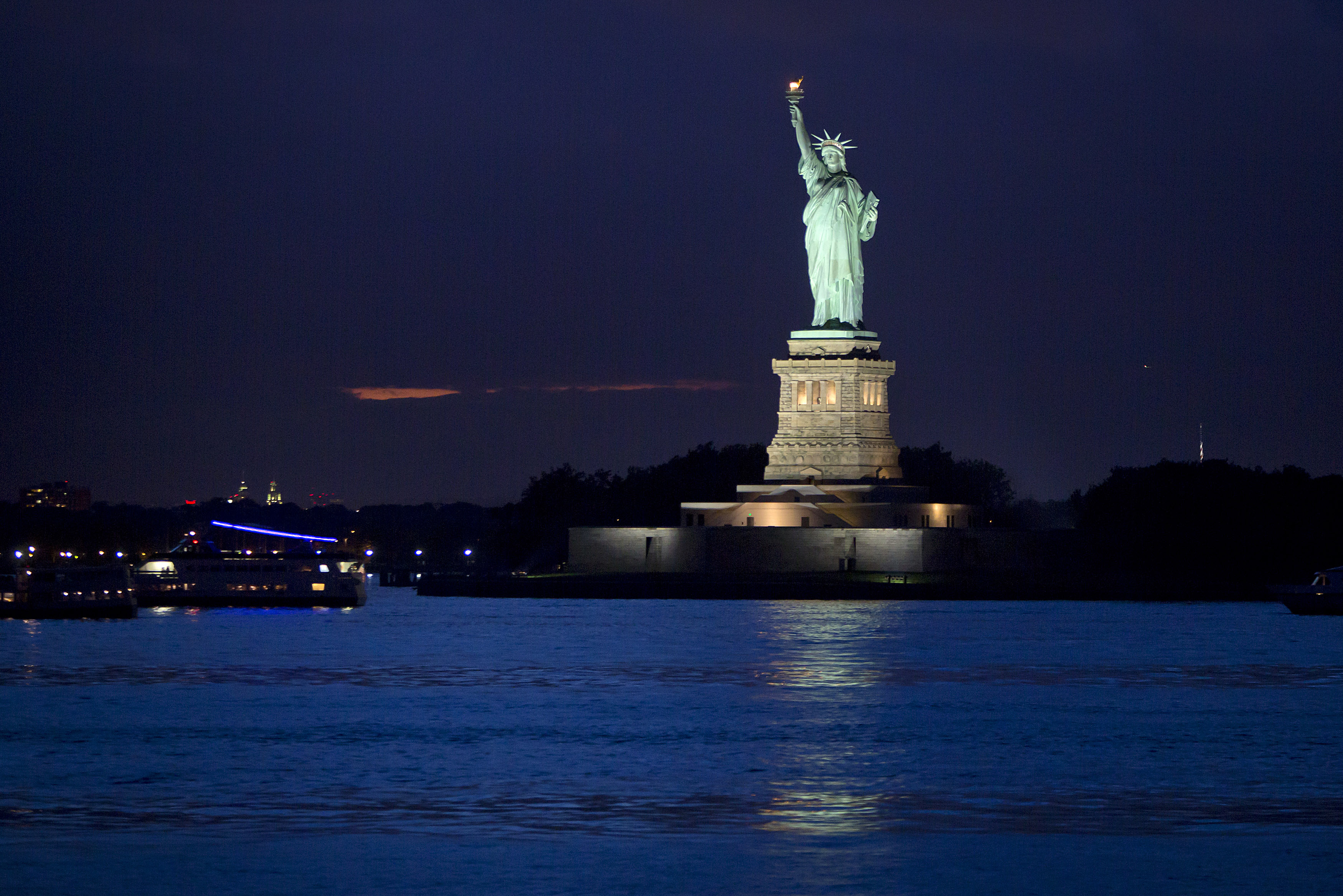 The Statue of Liberty is pictured from the Staten Island Ferry at twilight in New York