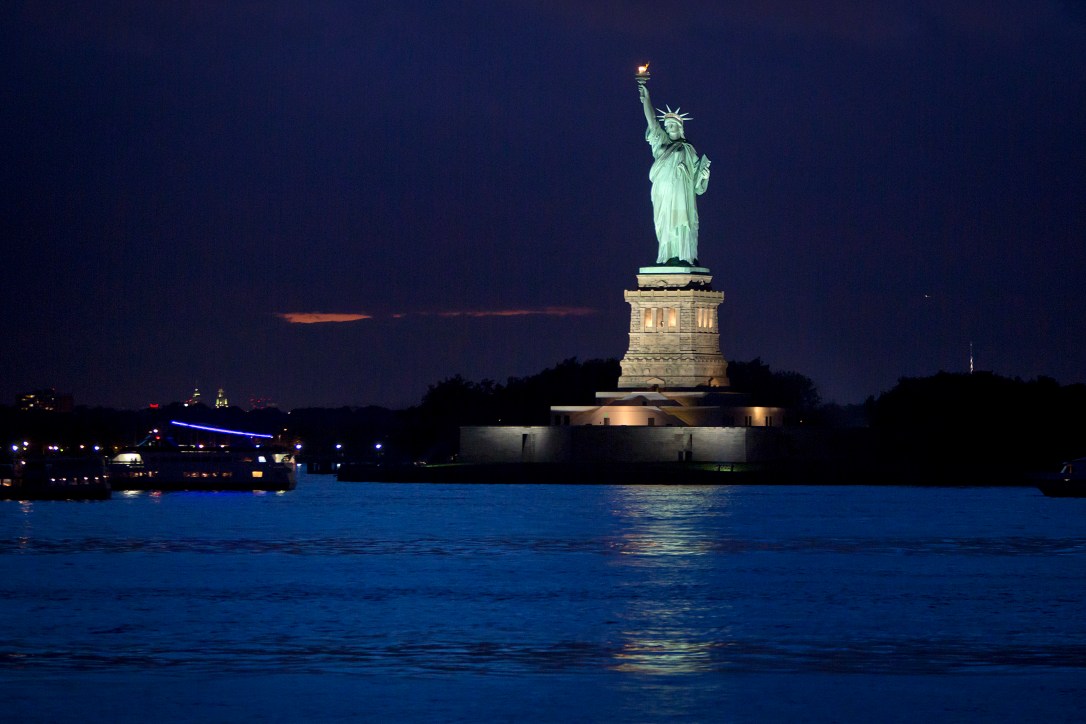 The Statue of Liberty is pictured from the Staten Island Ferry at twilight in New York
